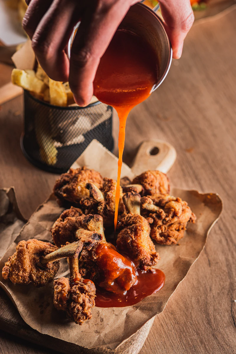 Wings drenched in house sauce