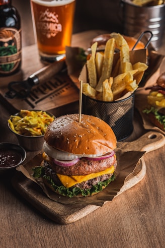 Juicy burger with fries and coleslaw on wooden table