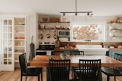 A cozy kitchen with a dining table and chairs.