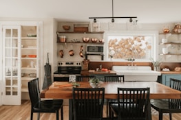 A cozy kitchen with a dining table and chairs.