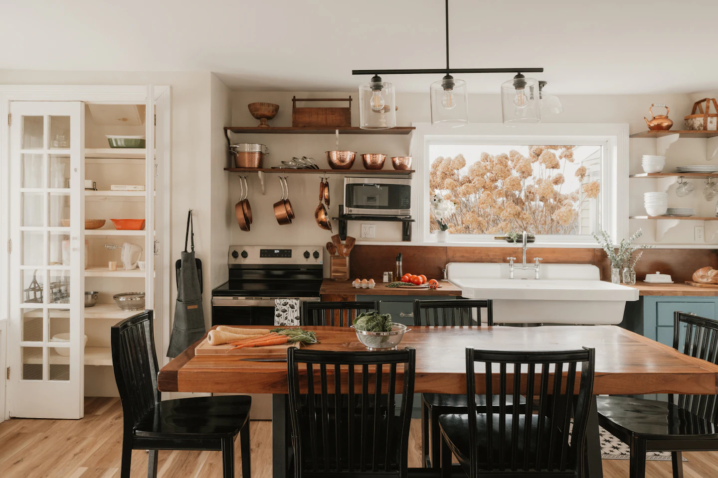 Cozy farmhouse kitchen with open shelving and a wood dining table