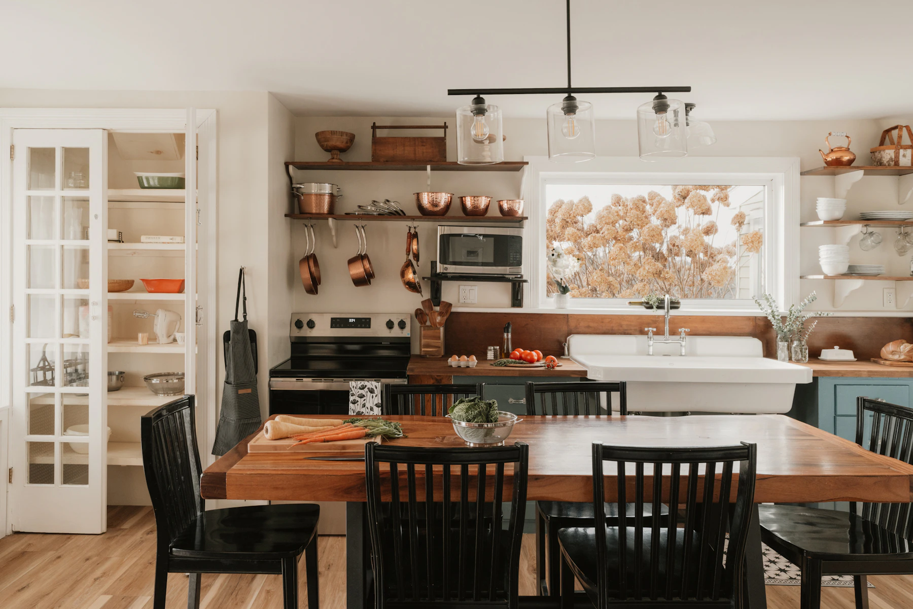 Warm dining nook with timber table, comfortable seating and focused pendant light