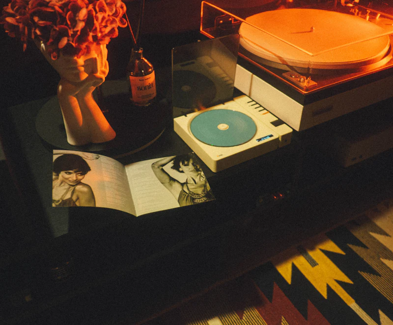 Vintage record player with an open magazine on a wooden table