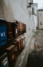Row of old mailboxes on a weathered wall