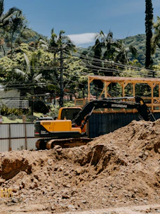 Yellow excavator working on a construction site.