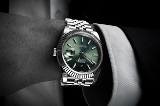 Man wearing a luxury wristwatch on his arm.
