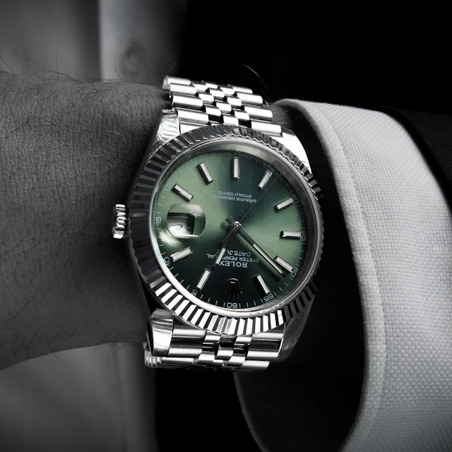 A man wearing a luxury wristwatch on his arm