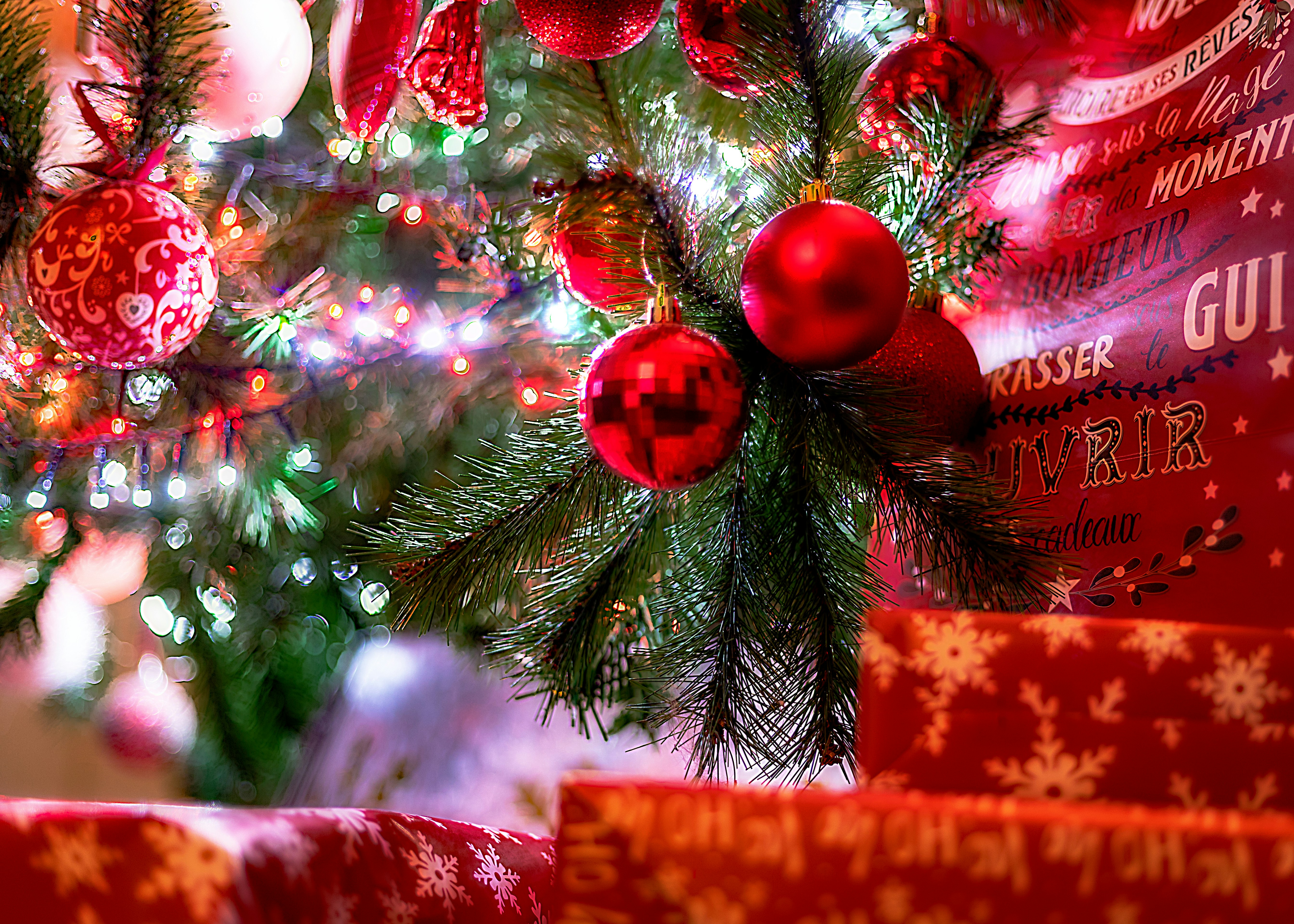 Christmas tree with red ornaments and gifts.