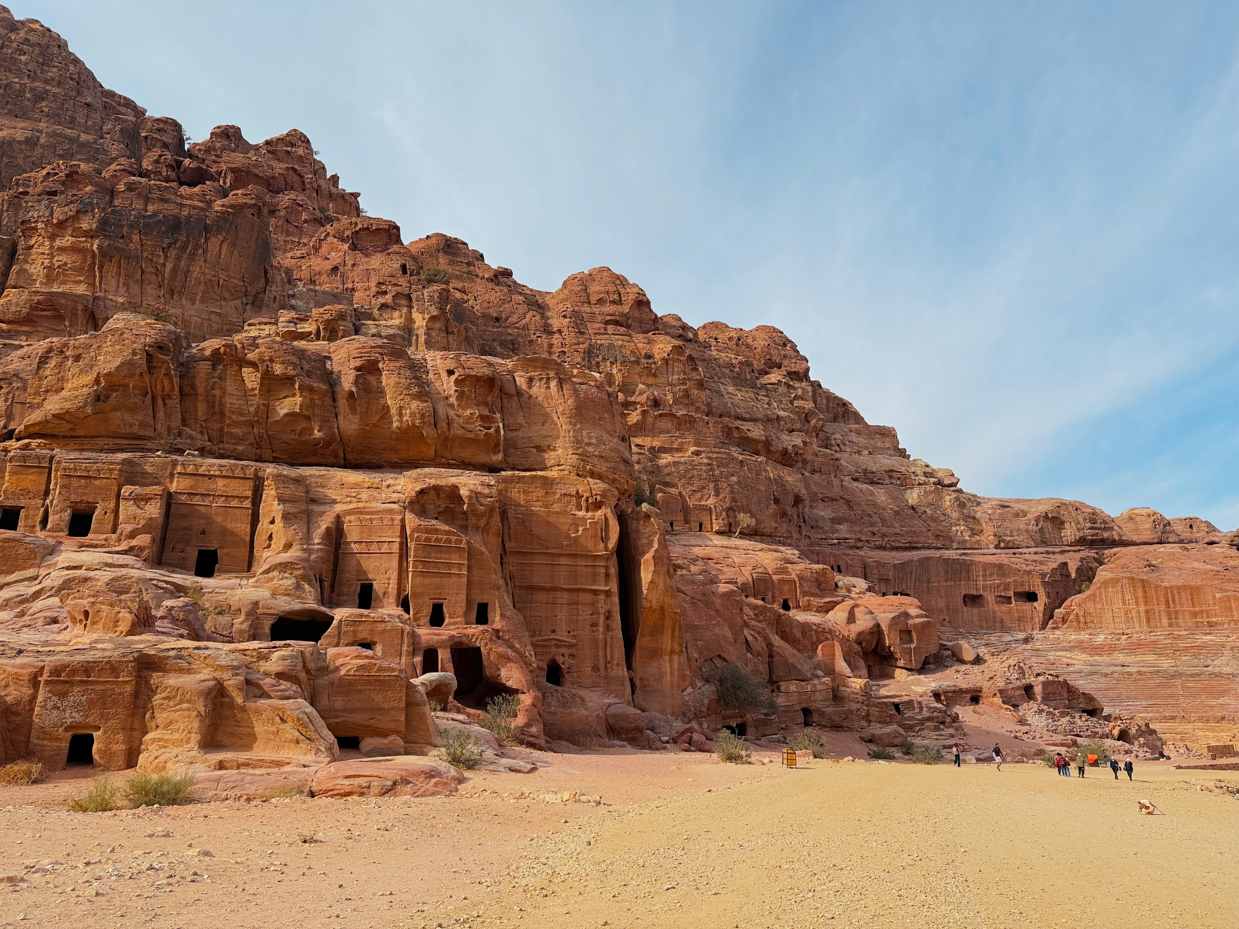 Ancient rock-cut structures carved into sandstone cliffs