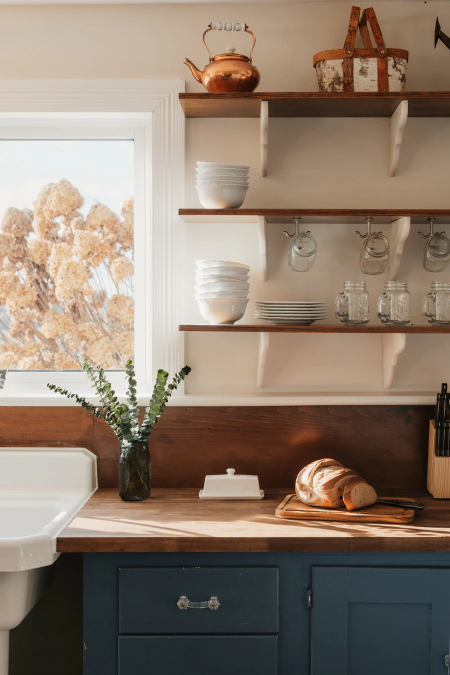 A rustic kitchen counter with bread and dishes