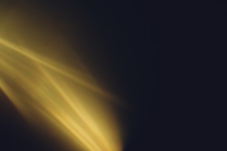 Golden light streaming through darkness — flame of eternal inspiration