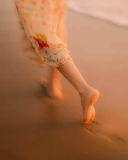 Bare feet walking on a wet sandy beach