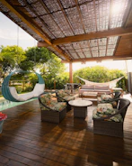 A beautiful patio with seating and a swing