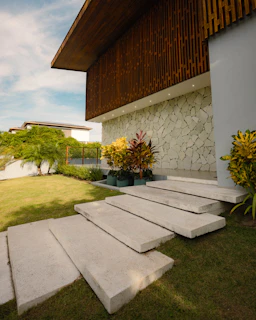 Modern house entrance with stone wall and garden