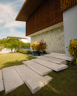 Modern house entrance with stone wall and garden