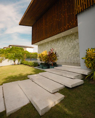 Modern house entrance with stone wall and garden