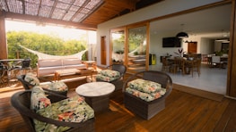 Outdoor patio seating area with a hammock and dining room.