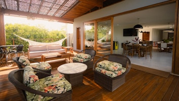 Outdoor patio seating area with a hammock and dining room.