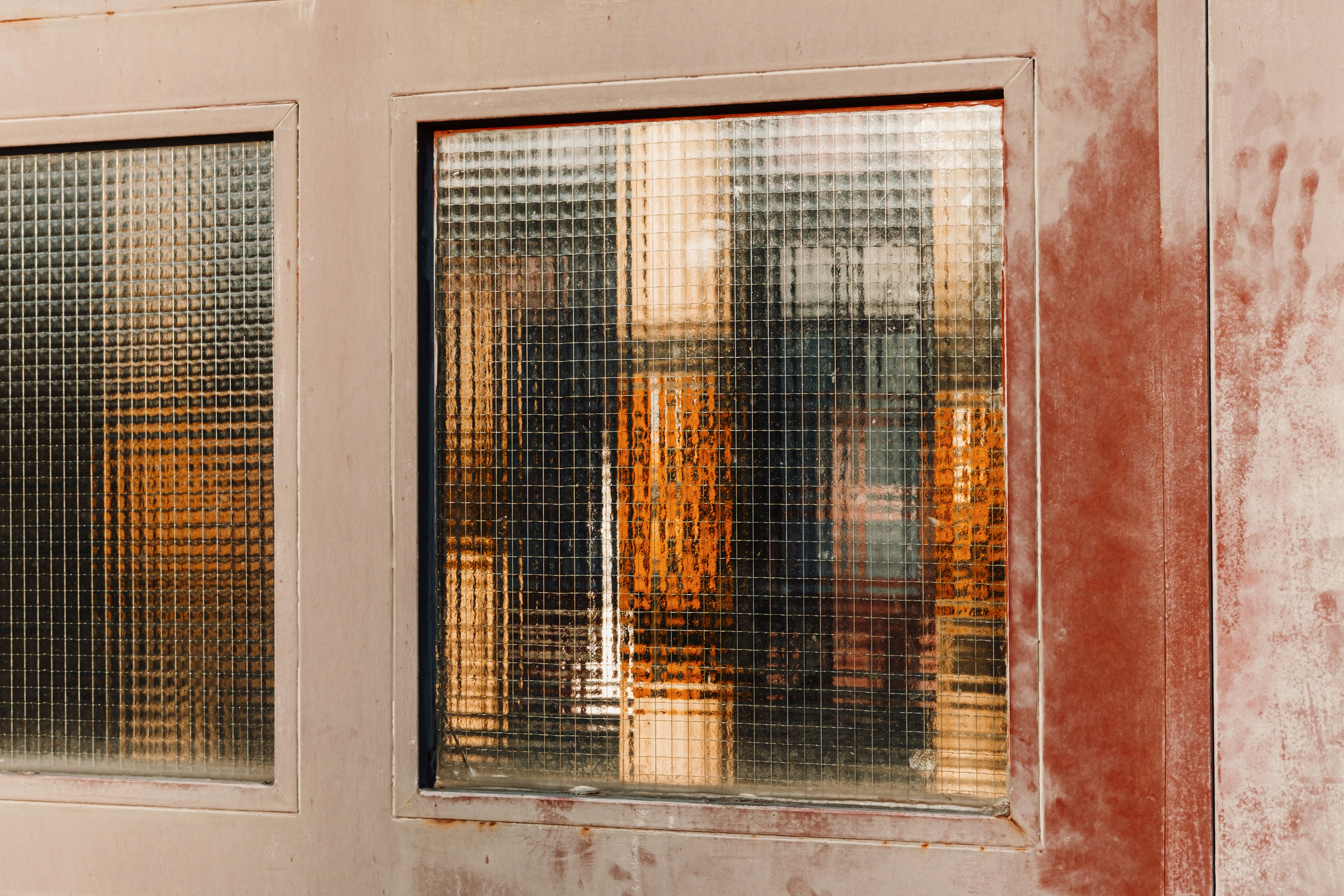 Frosted glass windows with reflections of warm colors