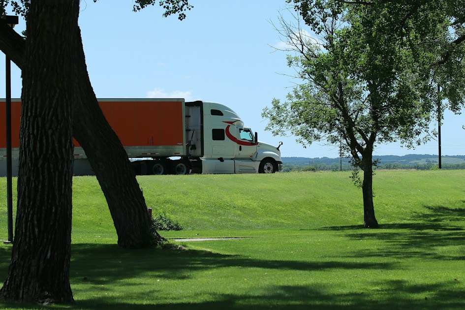 Semi truck with trailer driving on the highway