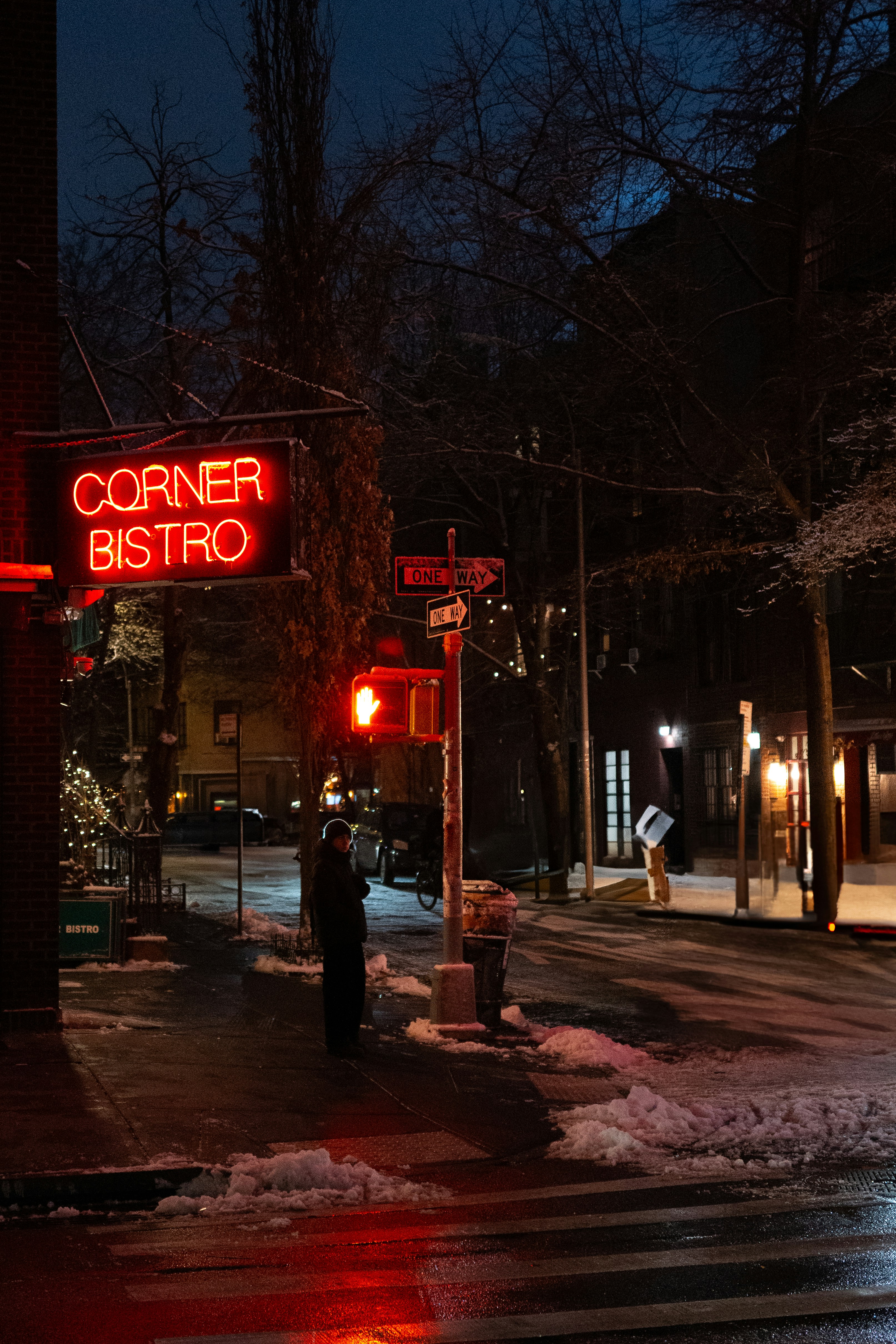 Corner bistro neon sign at night with snow