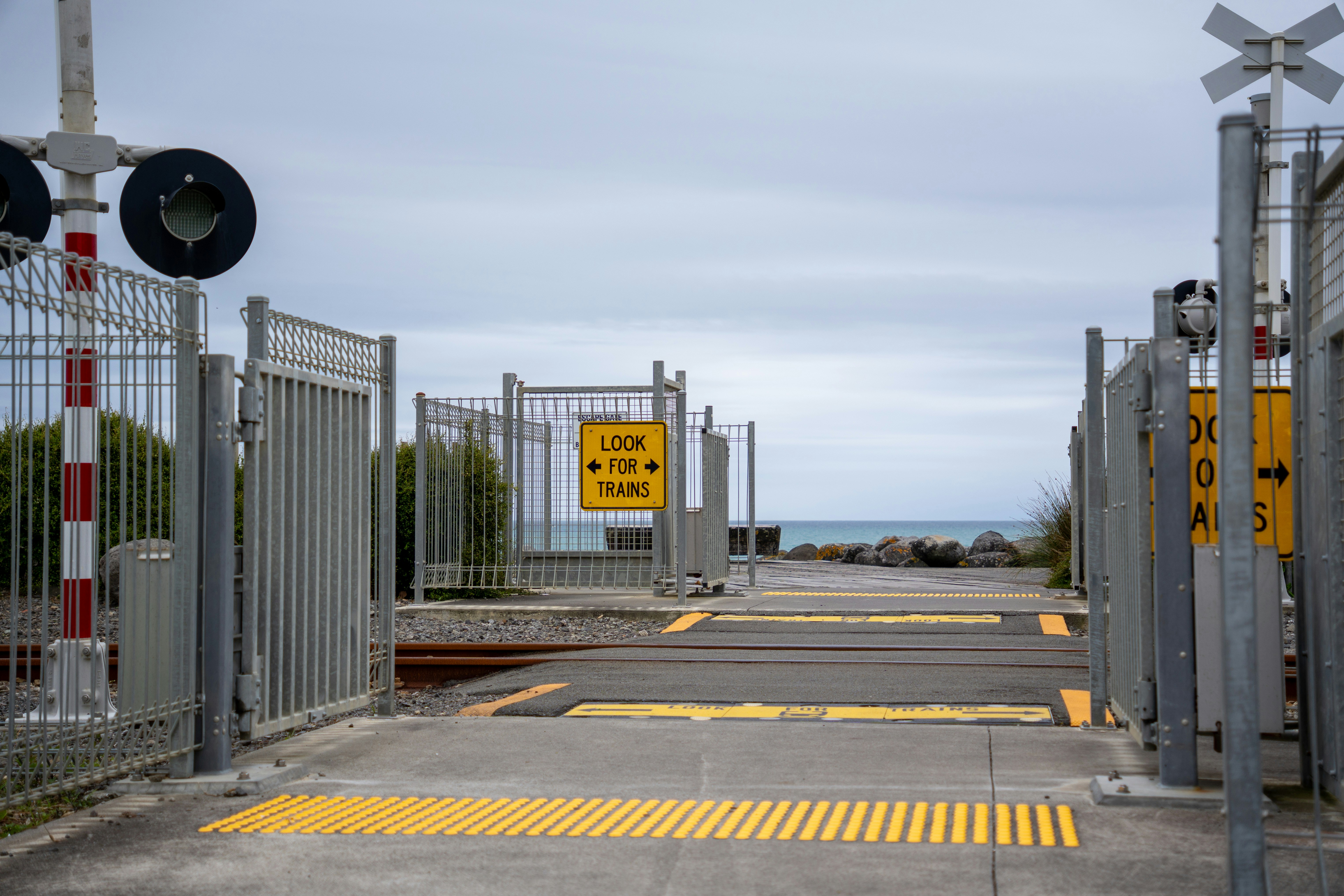 Bahnübergang mit Toren und Meerblick