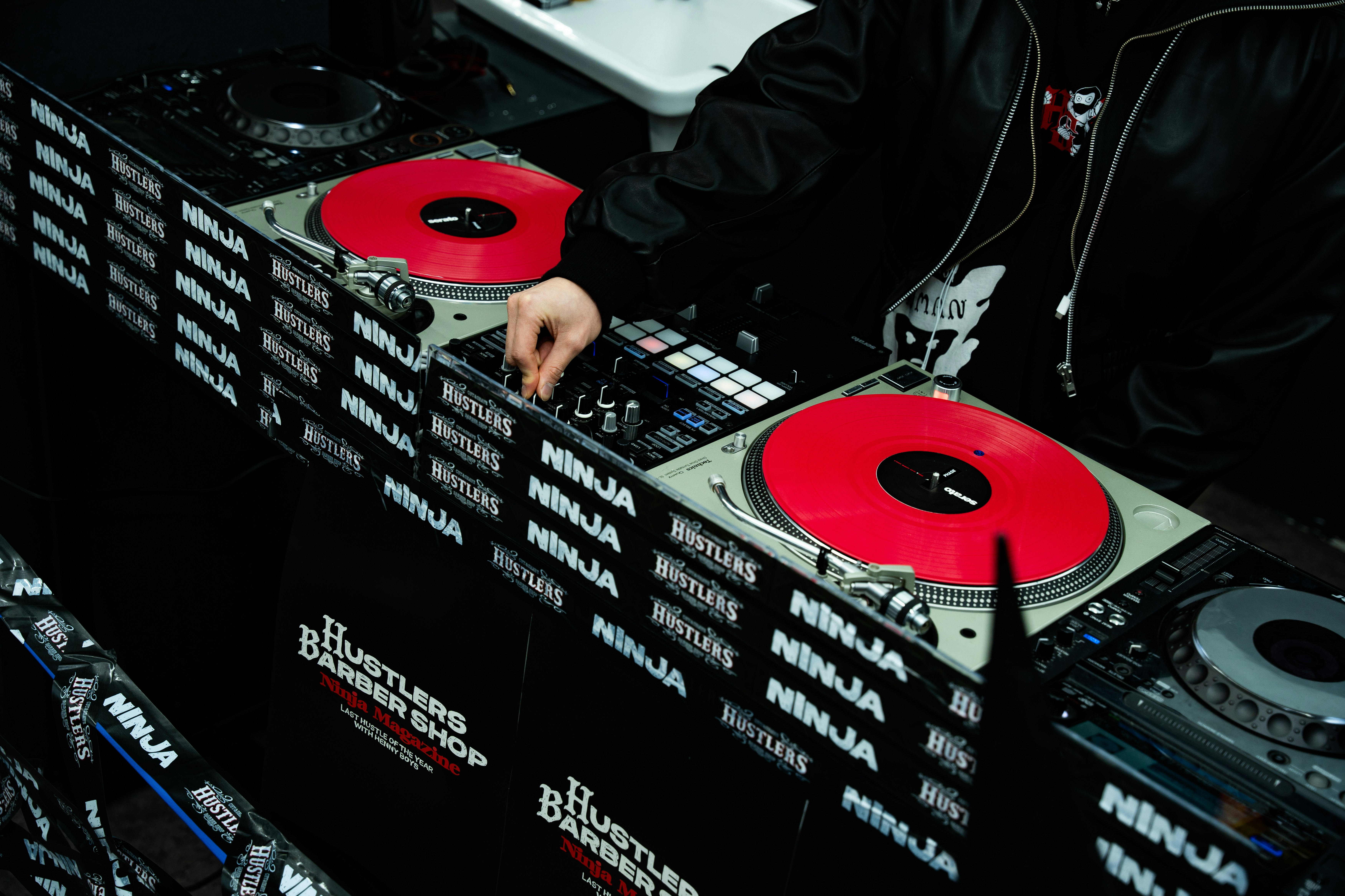 Dj mixing music on turntables with red vinyl records
