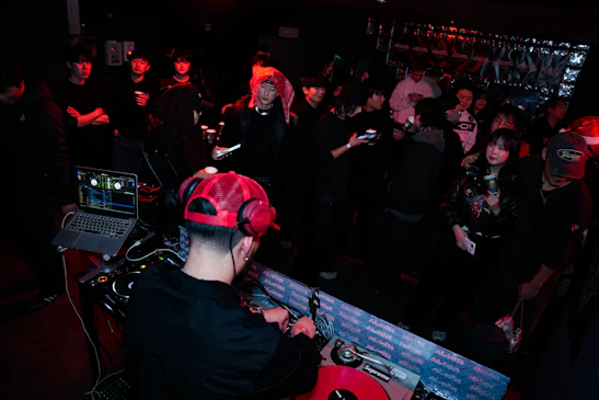Dj performing for a crowd at a nightclub
