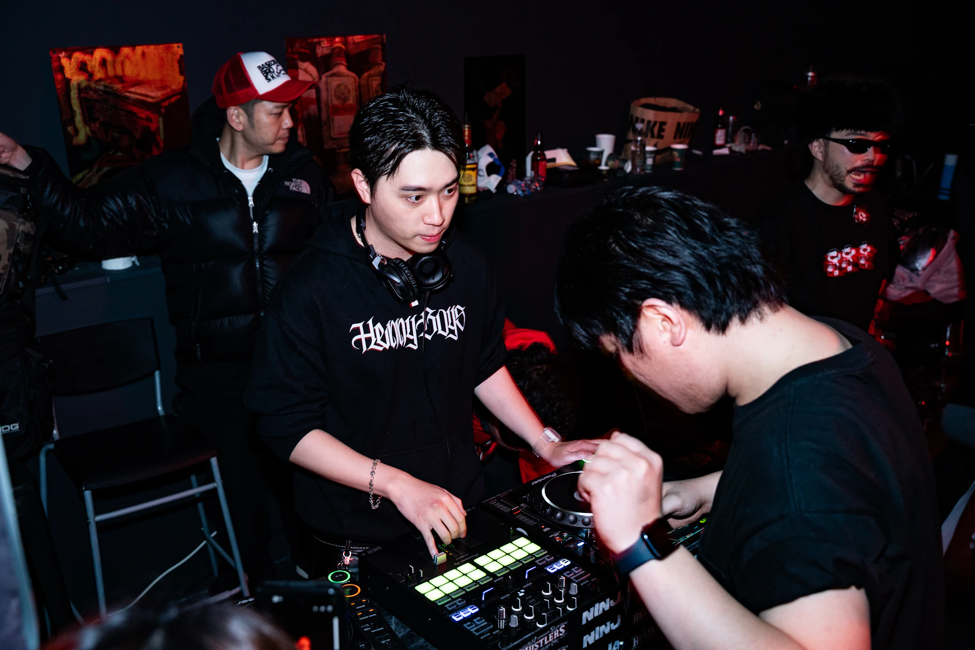 Two djs performing at a nightclub