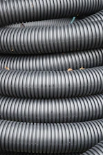 Coiled black corrugated plastic tubing