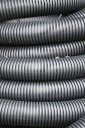 Coiled black corrugated plastic tubing