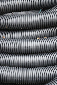 Coiled black corrugated plastic tubing