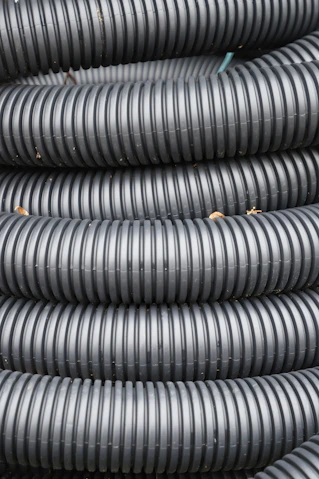 Coiled black corrugated plastic tubing