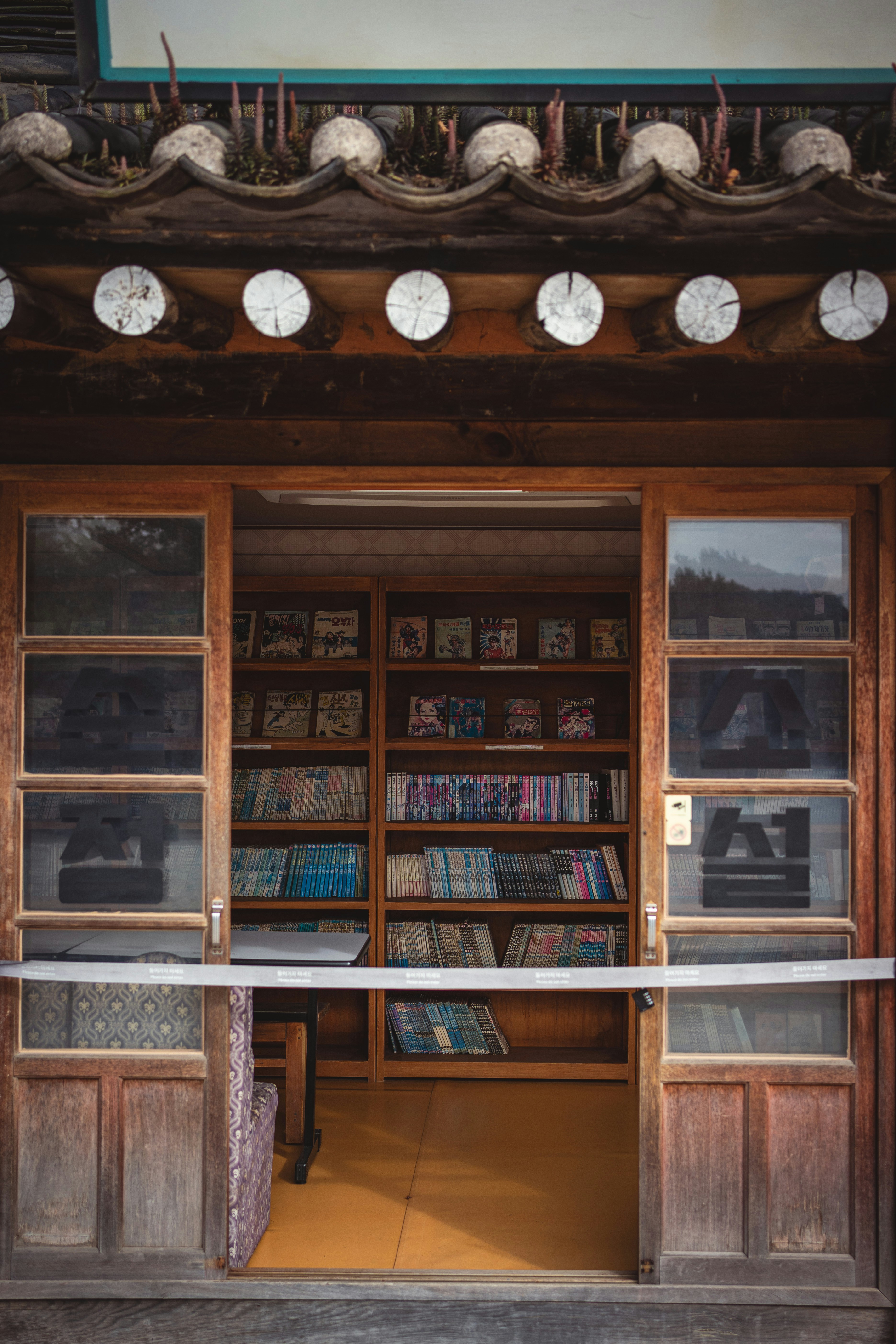 Wooden storefront with shelves full of books.