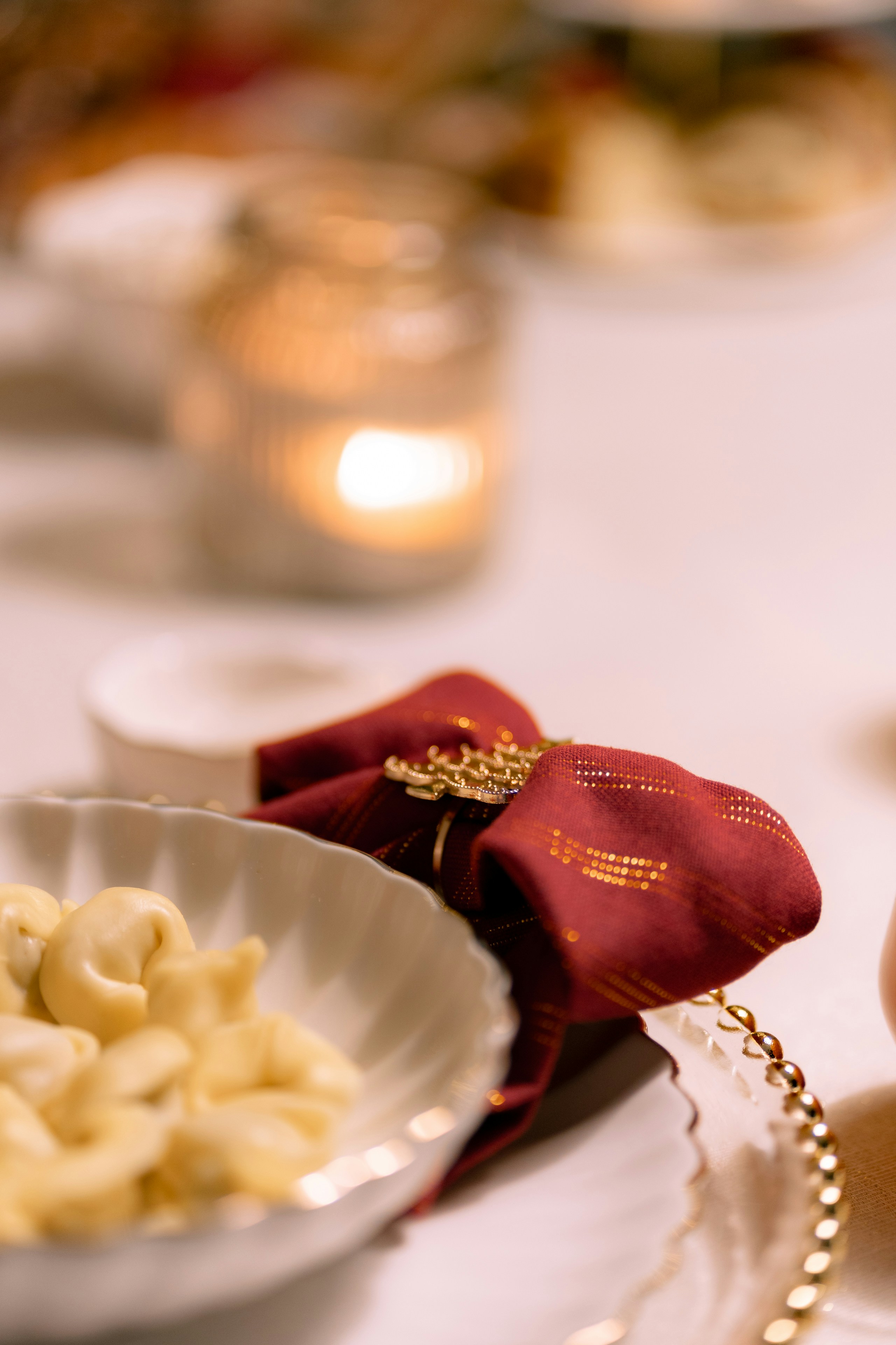 A festive table setting with cashews and a candle.