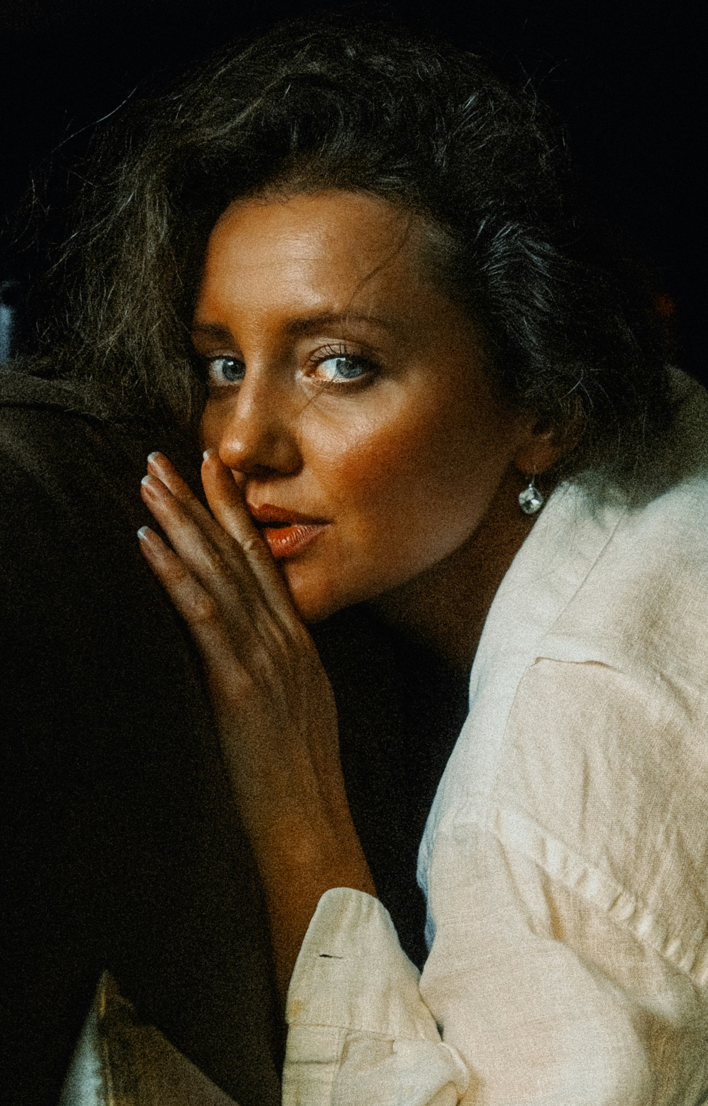 Woman whispering a secret with her hand over her mouth.