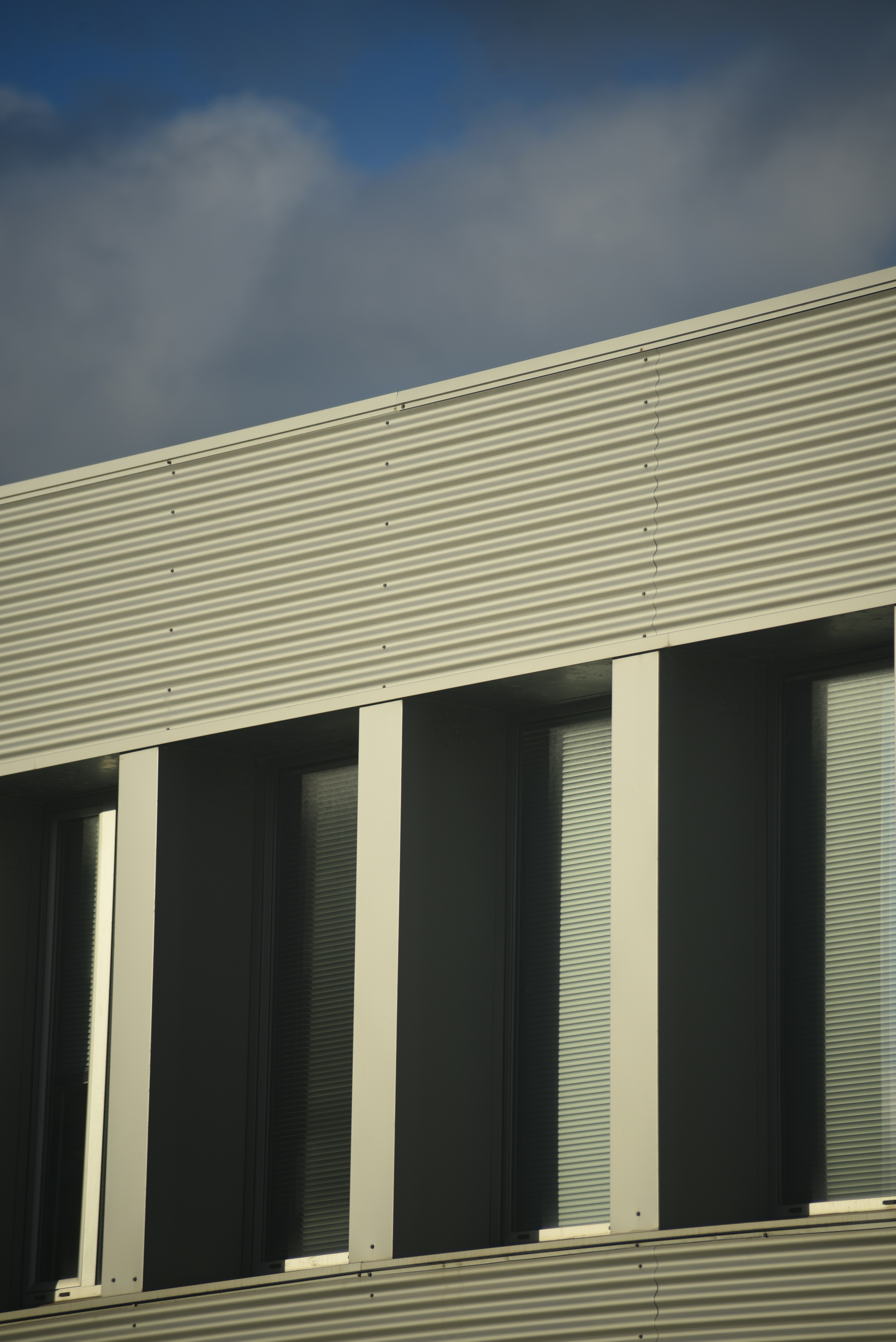 Modern building facade with corrugated metal and windows