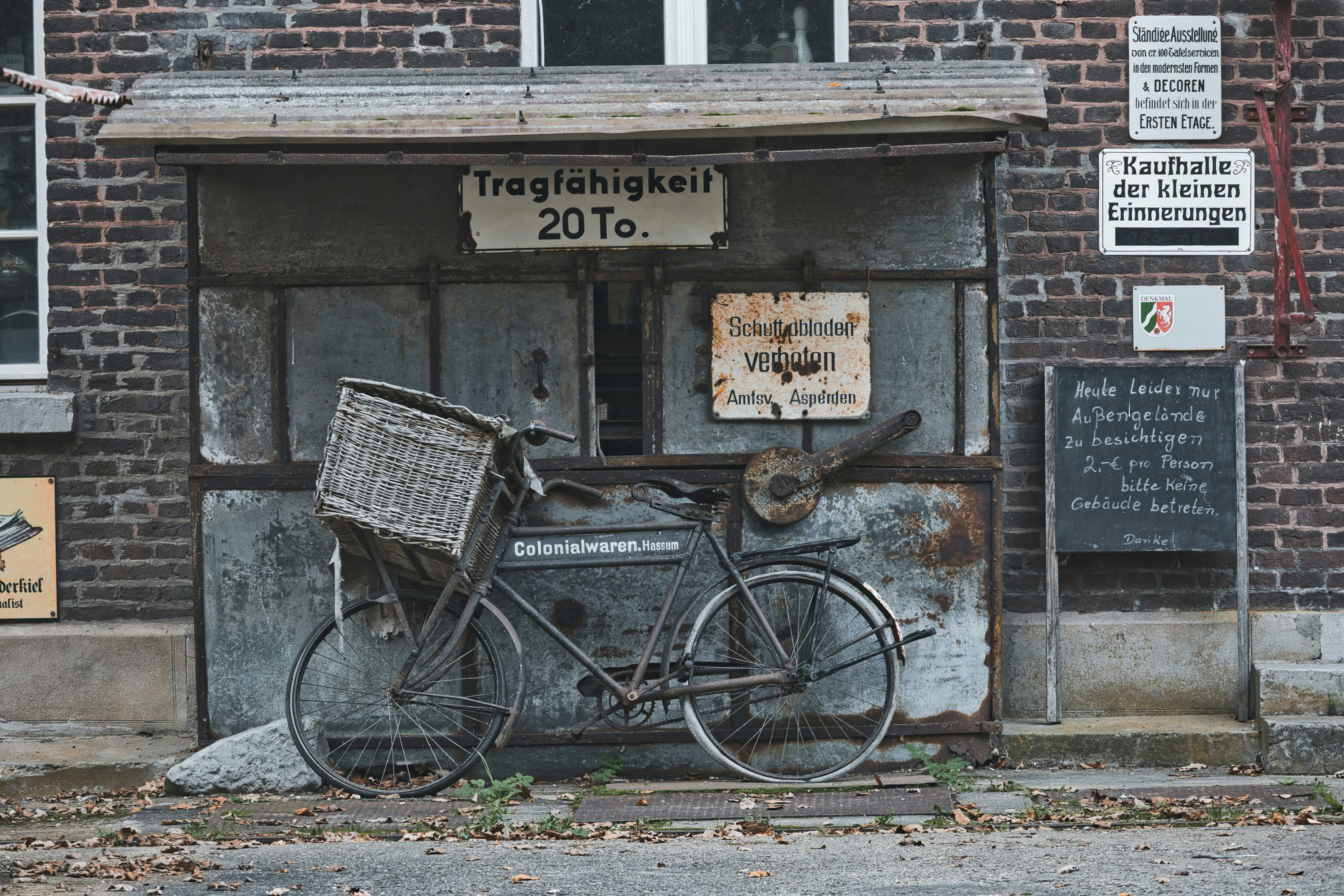 Old bicycle with basket in front of weathered building