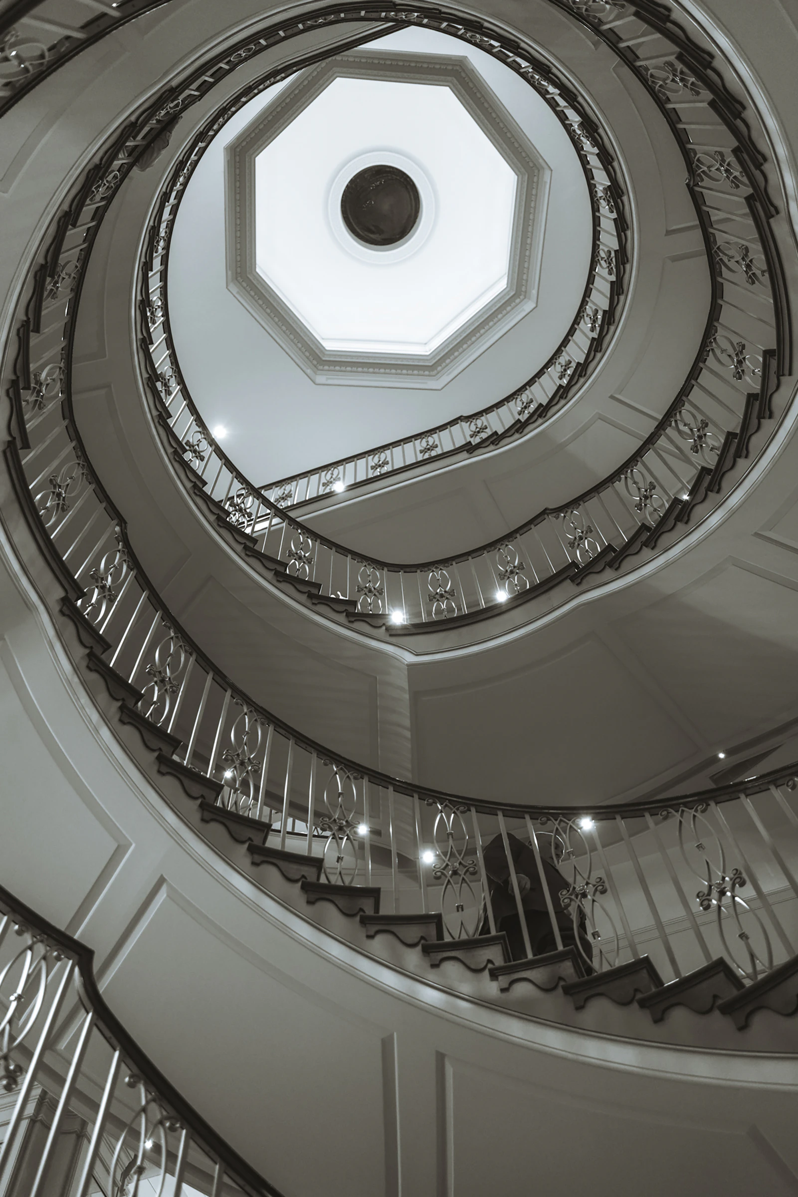 Elegant spiral staircase with ornate railings ascending upwards