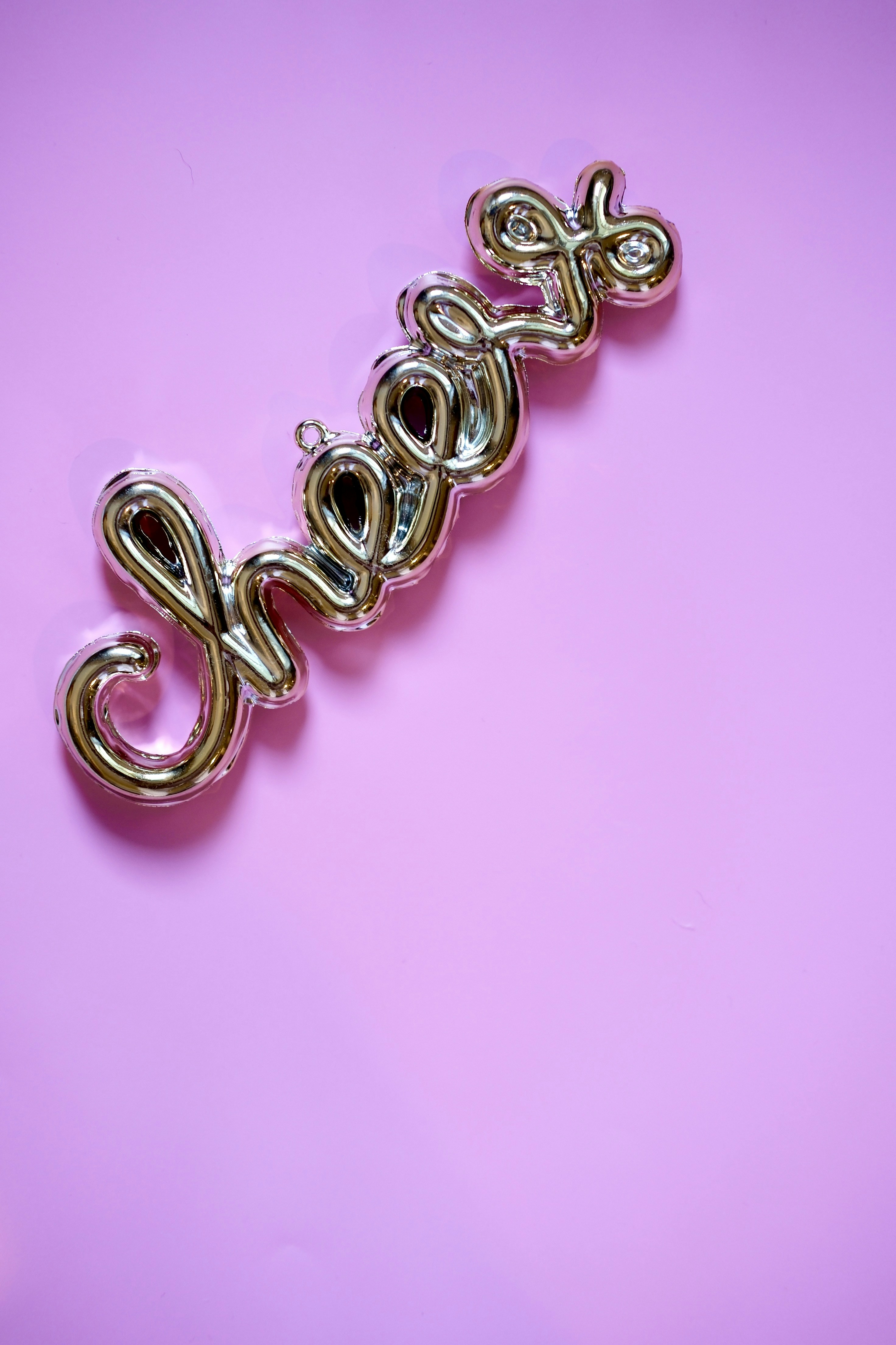 Golden "cheer" word on pink background