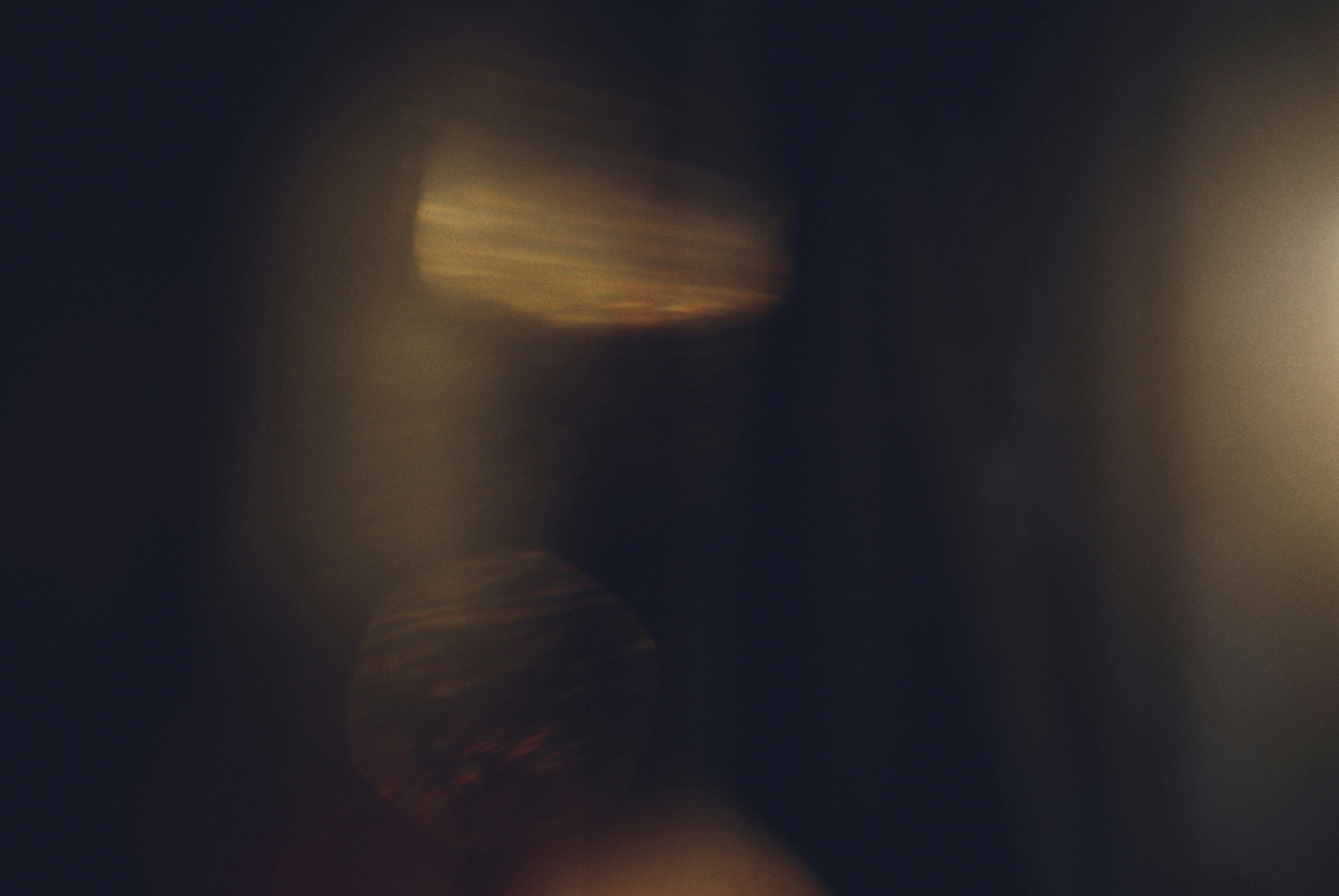 Abstract golden light streaks on dark background.