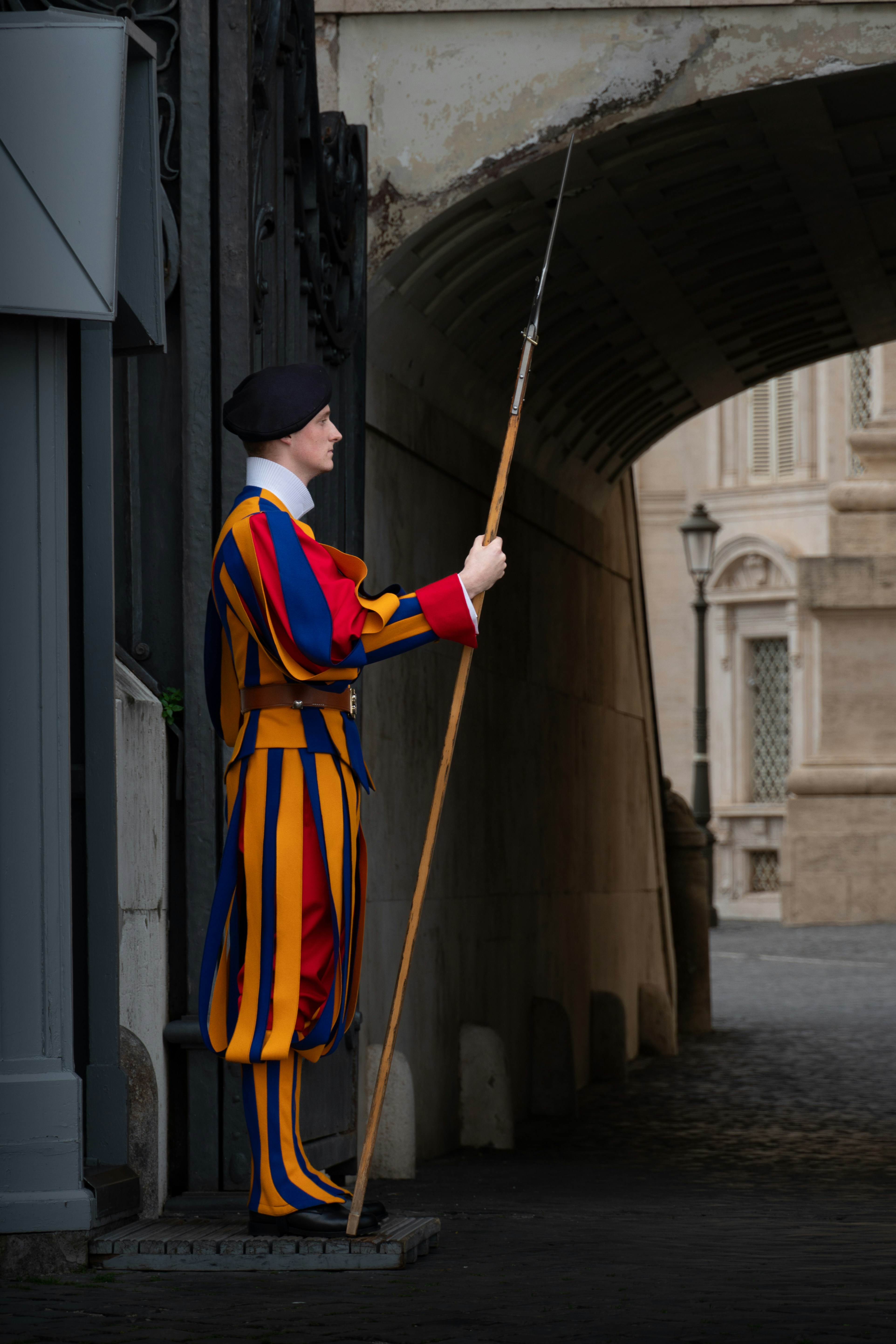 Swiss guard member in uniform holding a halberd