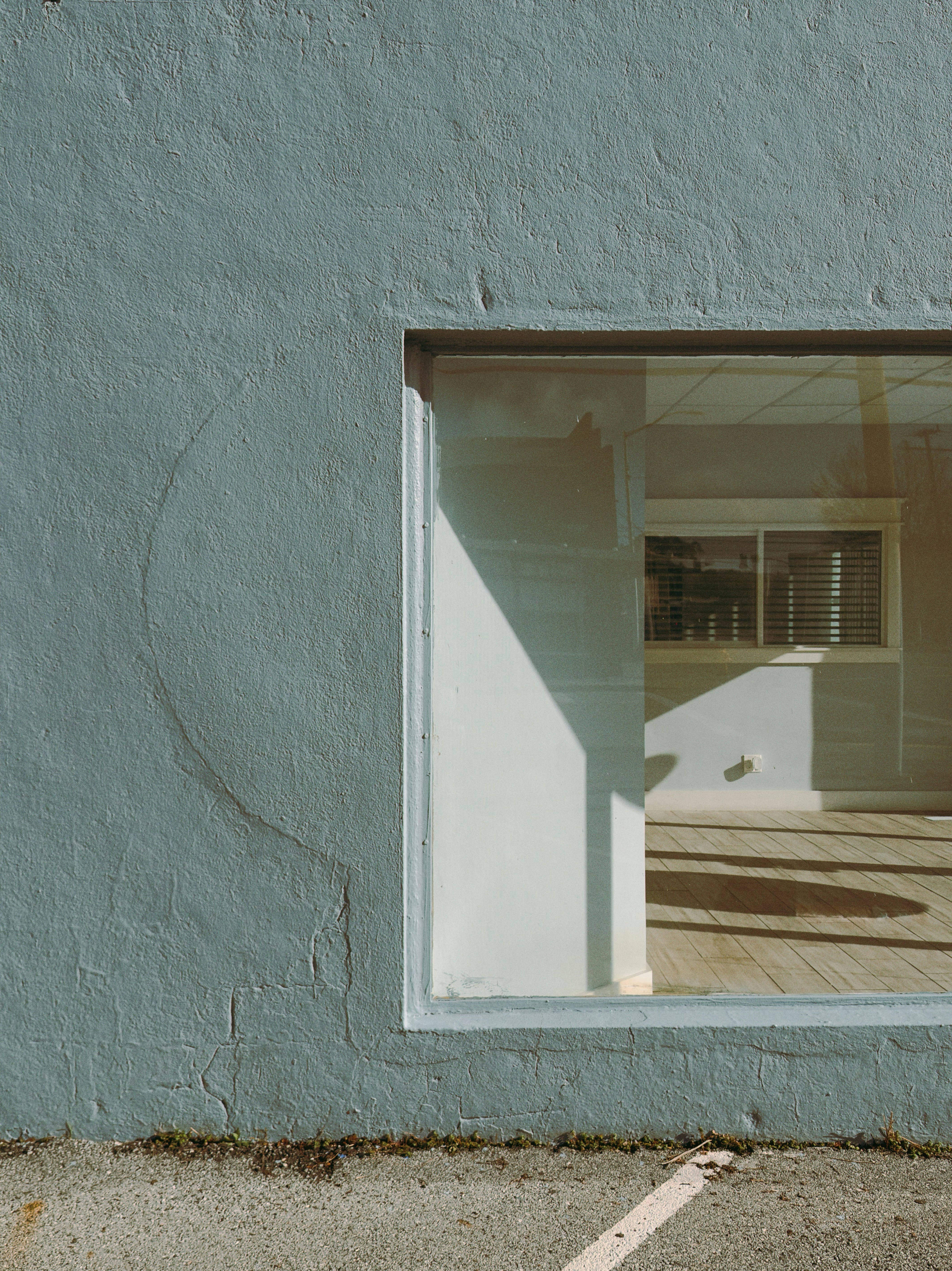 Light and shadow on a pale blue wall with window