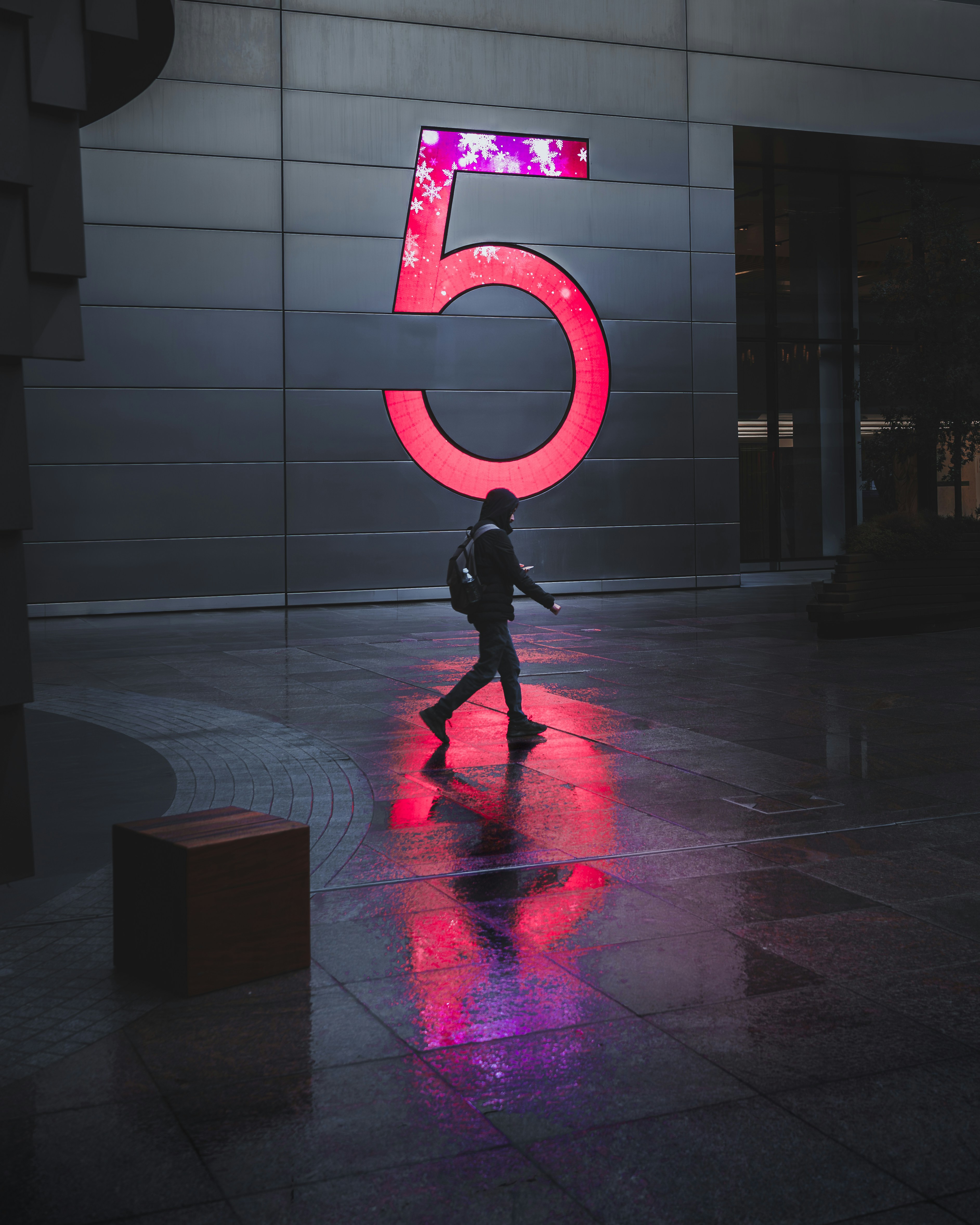 Person walks past a large glowing number five