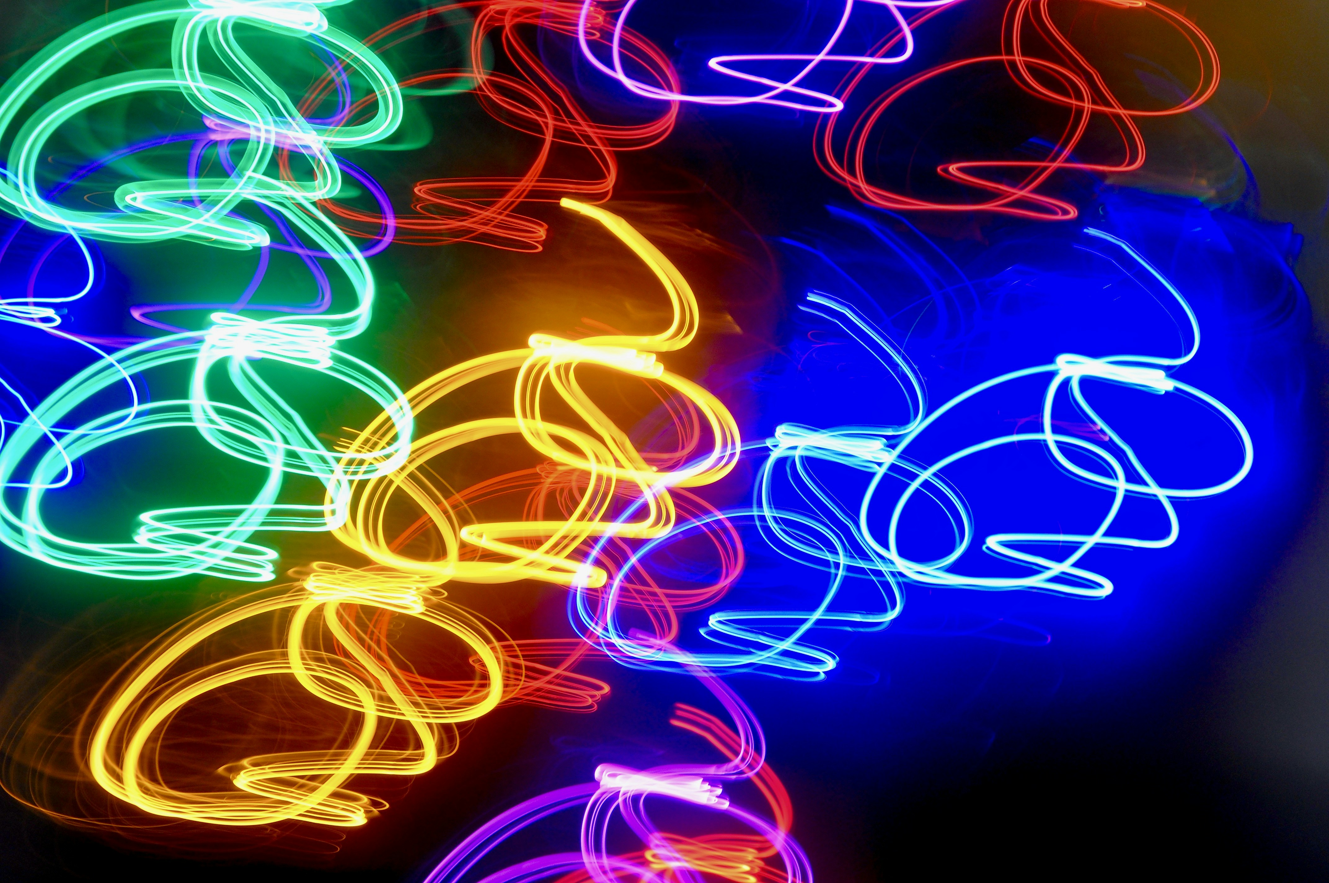 Abstract colorful light trails on dark background