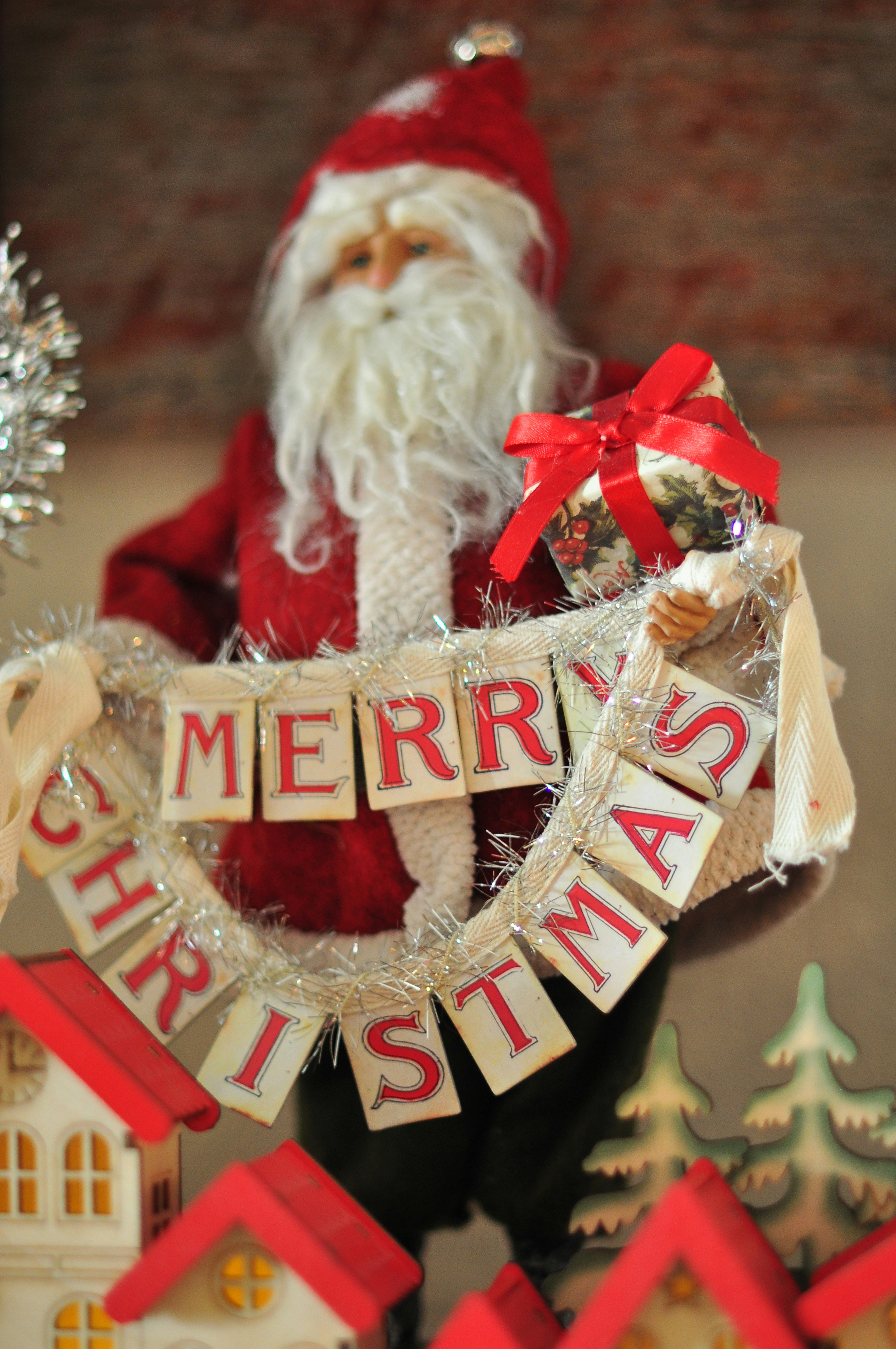 Santa claus holding a merry christmas banner