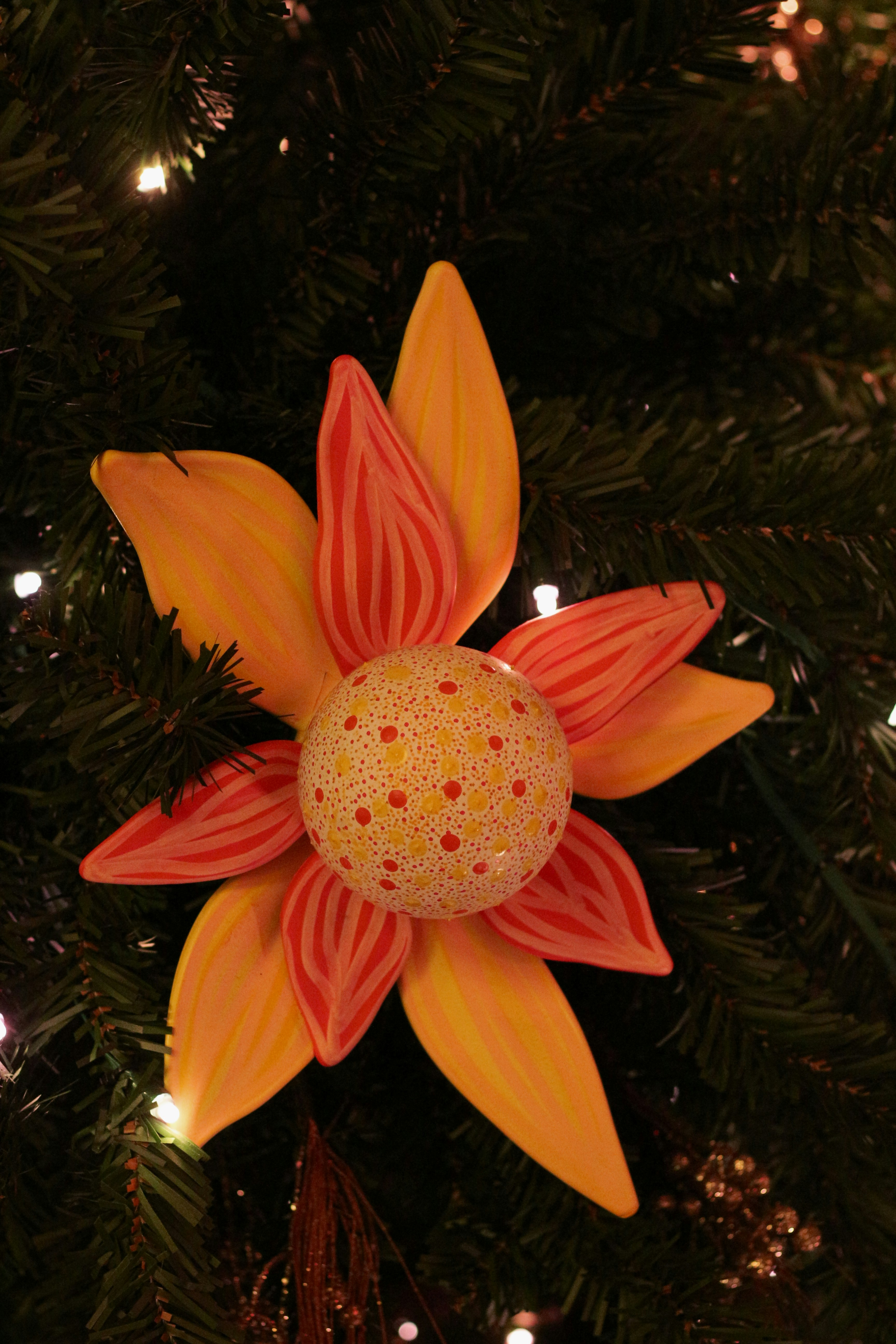 A decorative flower ornament on a christmas tree.