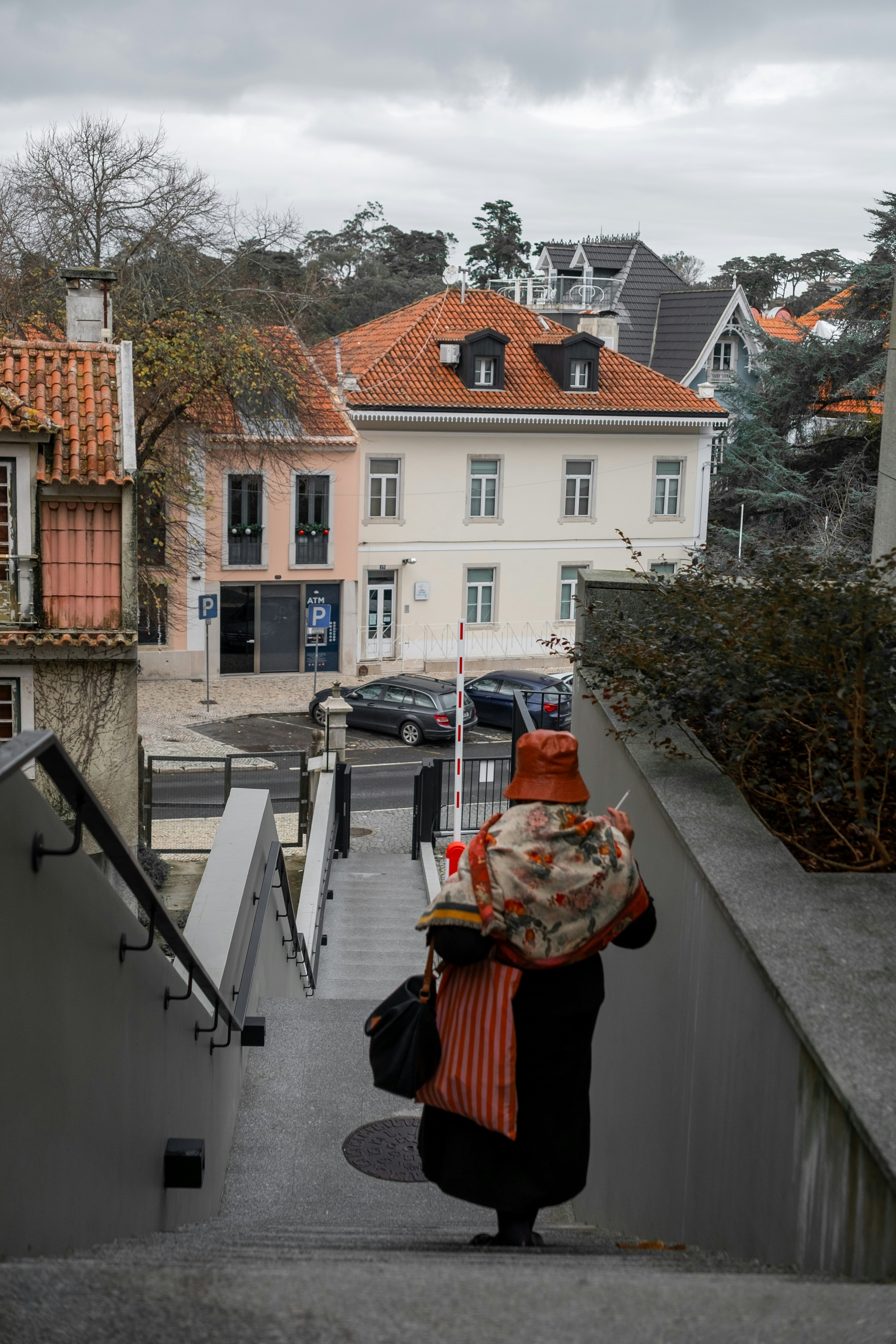 Woman in traditional clothing walks down stairs.