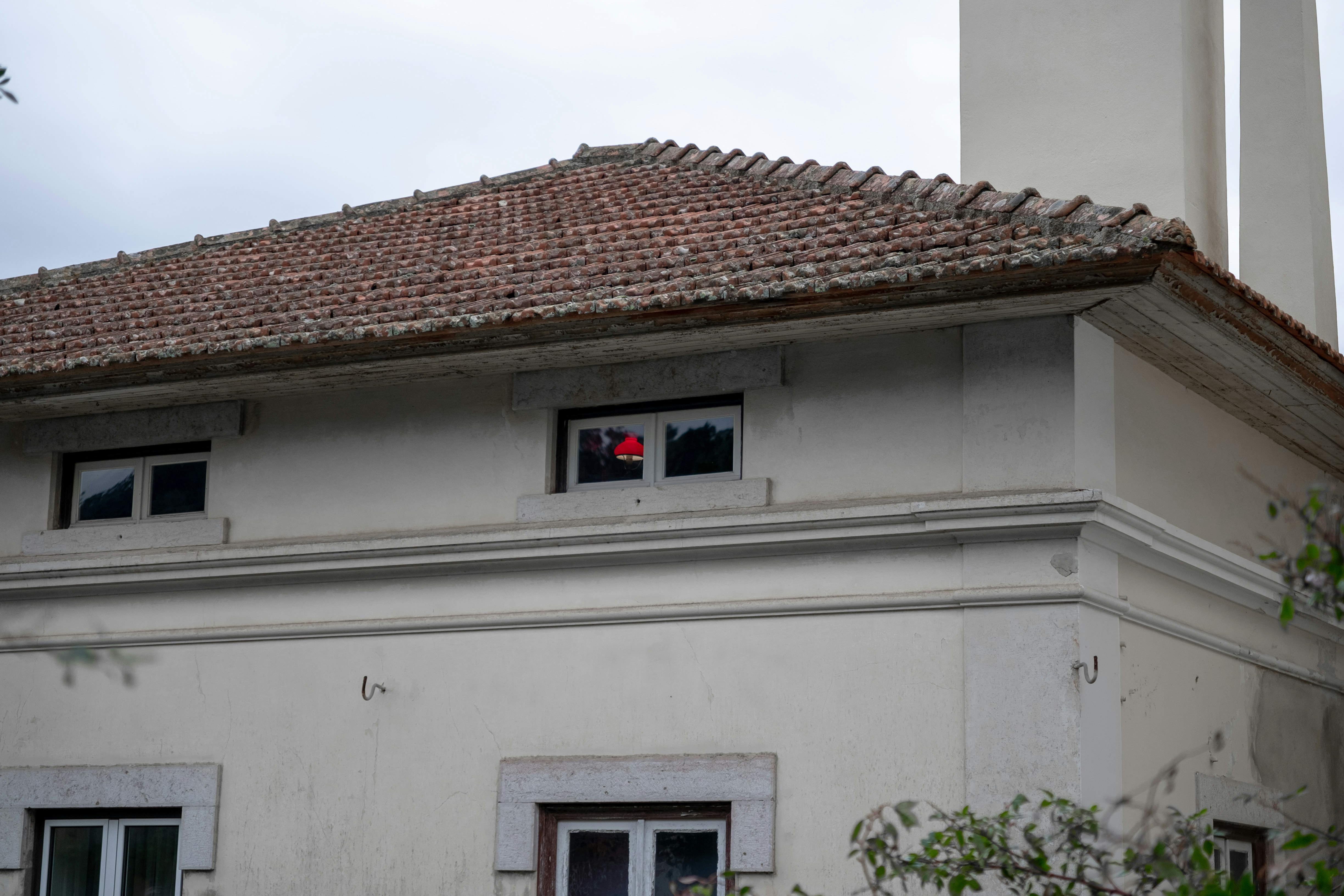 A red object visible in a window of a building.