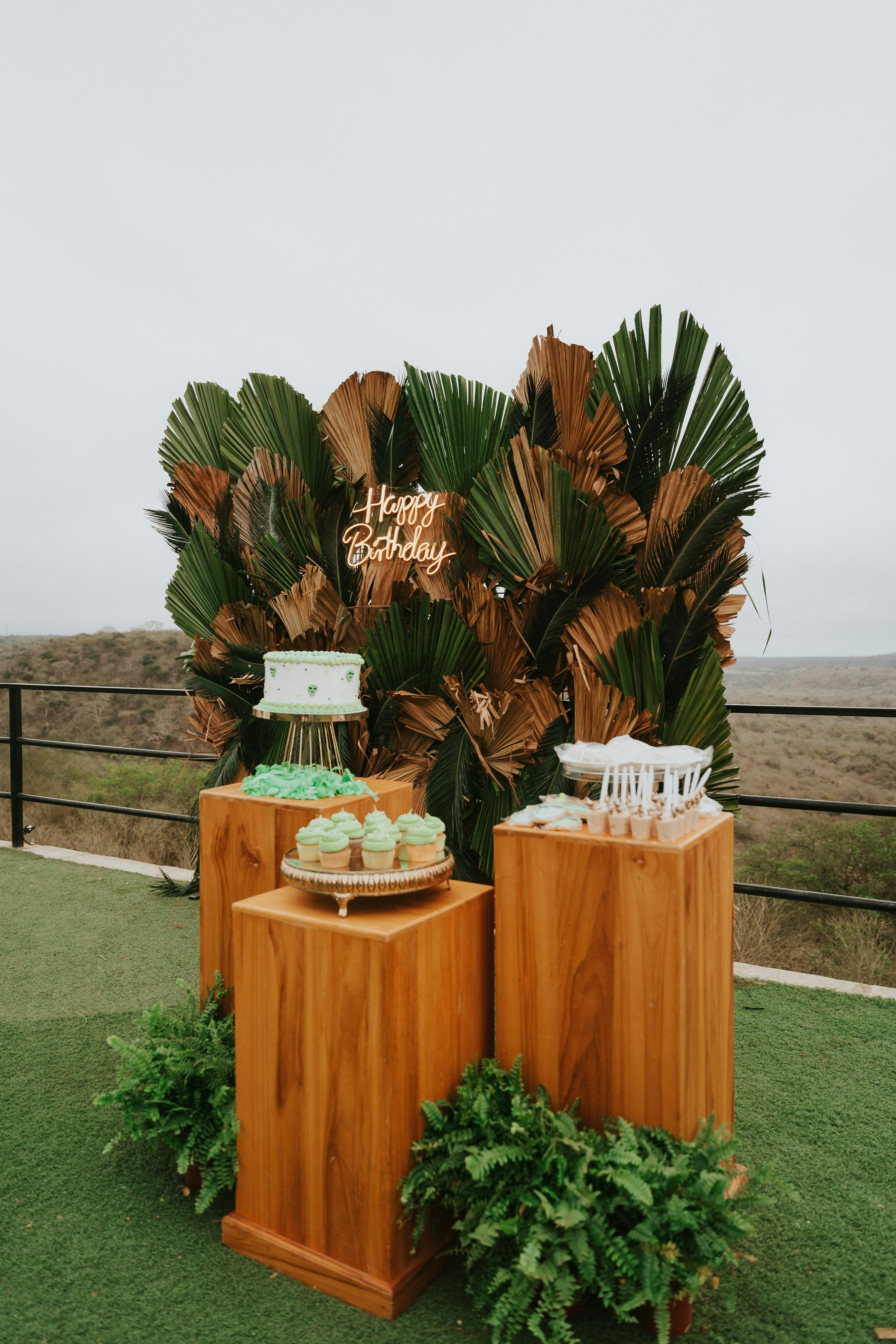 Birthday cake and cupcakes on wooden stands